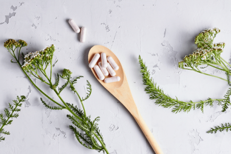 Capsules on wooden spoon